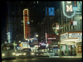 Theatre row on Granville Street in 1959, when Sunday movies were banned. The neon signs include the Capitol Theatre, Orpheum Theatre, Gurvin Jewelers, Castle Hotel, Krak-a-joke, the White Lunch and Antel's Ladies Wear. Note the Granville city bus has the old BC Electric logo on the front.