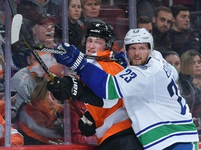 Alex Edler, right, couldn't or wouldn't say when he'll return to the Canucks' roster, but the Vancouver veteran has been missed. Coach Travis Green didn't rule out a return before Christmas.