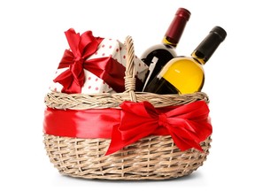 Festive basket with bottles of wine and gift on white background. Getty Images stock pic. For 1207 col gismondi [PNG Merlin Archive]