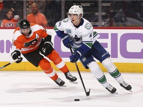 Elias Pettersson of the Vancouver Canucks controls the puck against Sean Couturier of the Philadelphia Flyers at the Wells Fargo Center on Nov. 25, 2019, in Philadelphia, Pennsylvania.