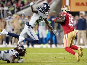 Wide receiver Deebo Samuel #19 of the San Francisco 49ers carries the ball against the defense of cornerback Tre Flowers #21 of the Seattle Seahawks during the game at Levi's Stadium on November 11, 2019 in Santa Clara, California.