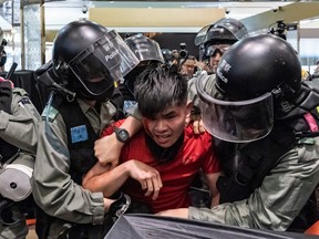 A man is detained by riot police during a demonstration in a shopping mall at Sheung Shui district on December 28, 2019 in Hong Kong, China.