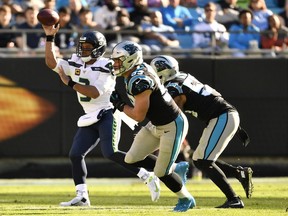 Seattle Seahawks quarterback Russell Wilson throws the ball under pressure in the first half against Carolina Panthers in the game at Bank of America Stadium on December 15, 2019.