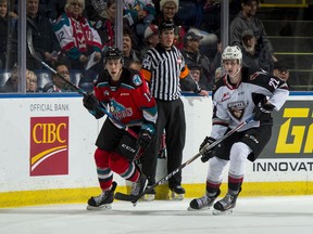 Connor Horning of the Vancouver Giants checks Ethan Ernst of the Kelowna Rockets during first period at Prospera Place on Wednesday.