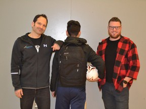 urrey Safe Schools team members Jon Ross, left, and Matt Huot, right, with their soccer playing refugee from the United States hoping to find a home in Canada.