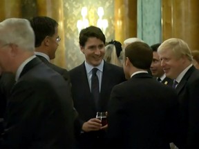 This grab made from a video shows Dutch Prime Minister Mark Rutte (L), French President Emmanuel Macron (front), British Prime Minister Boris Johnson (R) and Canada's Prime Minister Justin Trudeau (back-C) as the leaders of Britain, Canada, France and the Netherlands were caught on camera at a Buckingham Palace reception mocking U.S. President Donald Trump's lengthy media appearances ahead of the NATO summit on December 3, 2019 in London.