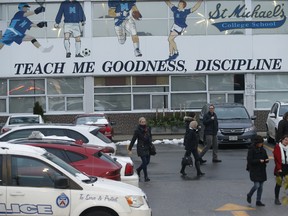 Parents, police and security could be seen guarding the back student's entrance doors at the rear of St. Michael's College on Bathurst St.