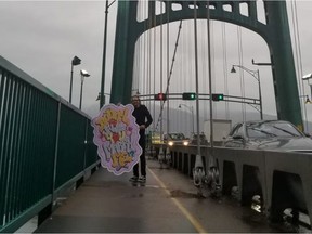 Vancouver resident Scotty Minch proposed to his girlfriend Bunny Blacklear on Thursday holding up a large sign to one of the highway cameras she monitors on the Lions Gate Bridge for her job.