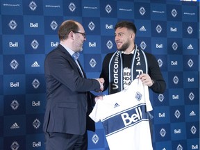 Vancouver Whitecaps sporting director Axel Schuster welcomes the team's newest signing, Canadian striker Lucas Cavallini, at a press conference on Dec. 16, 2019 at BC Place stadium in Vancouver. [PNG Merlin Archive]
