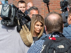 Actress Lori Loughlin and husband Mossimo Giannulli exit the Boston Federal Court house after a pre-trial hearing with Magistrate Judge Kelley at the John Joseph Moakley US Courthouse in Boston on August 27, 2019.