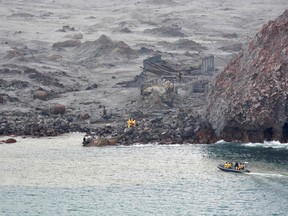 This handout photo taken and released on December 13, 2019 by the New Zealand Defence Force shows elite soldiers taking part in a mission to retrieve bodies from White Island after the December 9 volcanic eruption, off the coast from Whakatane on the North Island.