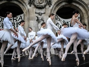 Paris Opera dancers perform in front of the Palais Garnier against the French government's plan to overhaul the country's retirement system, in Paris, on December 24, 2019.