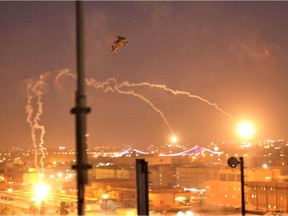 A handout picture received from the US embassy in Iraq on December 31, 2019, shows a US army apache helicopter dropping flares over Baghdad's high-security Green Zone on December 31, 2019, after Iraqi supporters of pro-Iran factions breached the outer wall of the US embassy over weekend air strikes that killed pro-Iran fighters in western Iraq. - The US State Department said that embassy personnel are safe and there are no plans to evacuate, after Iraqi supporters of pro-Iran factions attacked the compound. It is the first time in years that protesters have been able to reach the building, sheltered behind a series of checkpoints in the high-security Green Zone.