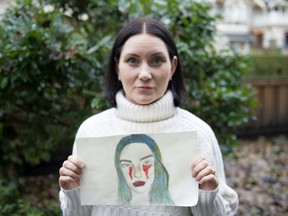 Natalie Boll, holding a picture her daughter drew, at her home on Dec. 17.