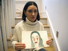 Natalie Boll, holding a picture her daughter drew.