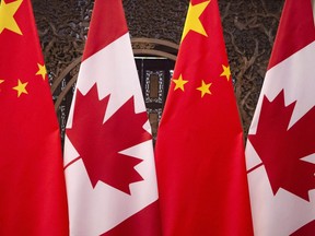 This Dec. 5, 2017, photo shows flags of Canada and China prior to a meeting of Canadian Prime Minister Justin Trudeau and Chinese President Xi Jinping at the Diaoyutai State Guesthouse in Beijing. China's embassy in Ottawa is taking a swing at the Trudeau Liberals over fresh comments on the source of the diplomatic difficulties between the two countries.