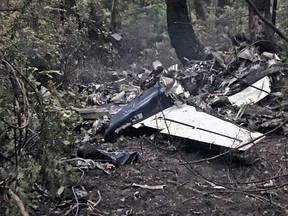 The scene of a small plane crash on Gabriola Island, B.C., is shown on Wednesday, Dec.11, 2019. A plane that one witness describes as crashing in a "huge explosion" that left multiple people dead in British Columbia has been identified as a twin-engine propeller aircraft.