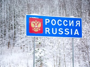 Russian Federation national border sign during winter.