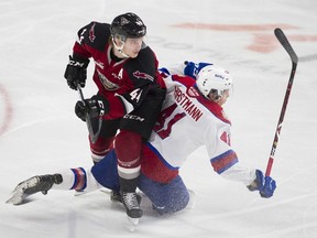 Defenceman Bowen Byram of the Vancouver Giants and Edmonton Oil Kings' Tyler Horstmann collide in a WHL game at Langley Events Centre on Nov. 23.
