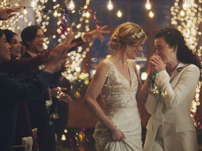 This image made from undated video provided by Zola shows a scene of its advertisement. Under pressure from a conservative advocacy group, The Hallmark Channel has pulled the ads for wedding-planning website Zola that featured same-sex couples, including two brides kissing. The family-friendly network, which is in the midst of its heavily watched holiday programming, removed the ads because the controversy was a distraction, a spokesperson said in an interview on Saturday, Dec. 14, 2019.