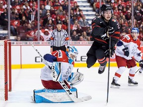 Czech Republic goalie Jakub Skarek, left, makes the save as Canada's Barrett Hayton jumps to screen him during world junior action in Vancouver, on Saturday December 29, 2018. (THE CANADIAN PRESS/Darryl Dyck)