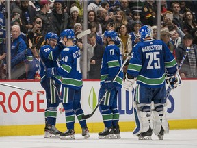 Elias Pettersson and his teammates celebrate their win on Thursday.