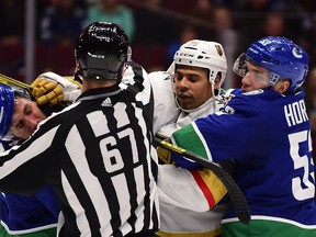 Las Vegas Golden Knights forward Ryan Reaves (75) fights Vancouver Canucks forward Josh Leivo, left, during the second period of Thursday's NHL tilt at Rogers Arena in Vancouver.