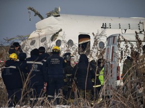 Emergency and security personnel are seen at the site of a plane crash near Almaty, Kazakhstan, Dec. 27, 2019.