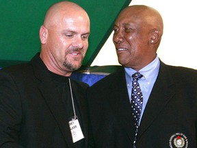 Larry Walker receives congratulations from Fergie Jenkins upon his induction into the Canadian Baseball Hall of Fame.