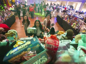 Volunteers sort out the packages donated to the 13th annual Victor Ghirra toy drive on Saturday in Richmond.