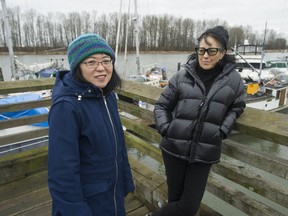 Lorene Oikawa, left, the president of the National Association of Japanese Canadians and Susanne Tabata, also of the NAJC, stand across the Fraser River from Don Island in Richmond on Dec. 28. Don Island was previously known Oikawa Island.