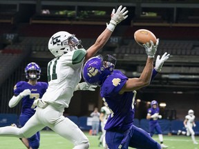 Jason Soriano of the Vancouver College Fighting Irish makes a catch against Lord Tweedsmuir Panthers' Jaxon Stebbings during the AAA BC High School Football Championships at B.C. Place in Vancouver Saturday.