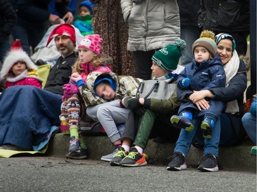 A young person sleeps as others enjoy the Santa Claus Parade in Vancouver, BC, December 1, 2019.  (Arlen Redekop / PNG staff photo) (story by reporter) [PNG Merlin Archive]