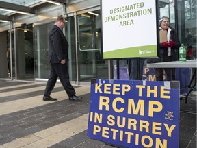 A man walks past the "Designated Demonstration Area" outside City of Surrey's city hall prior to the start of a budget meeting in Surrey, December, 2, 2019.