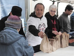 Alex Watts, a formerly homeless man, and his crew of 34 volunteers handed out over 500 packages of urkey sandwiches, mandarin oranges, juice boxes, pastries and hot chocolate on the Downtown Eastside on Wednesday.