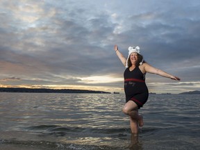 Lisa Pantages, wearing her grandfather's swimming suit, poses for a photo at English Bay on Saturday to promote this year's 100th anniversary of the popular New Year's Day Polar Bear Swim in Vancouver. Lisa's grandfather, Peter Pantages, was the founder of the festive tradition.