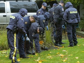 RCMP investigation in 2007 of the murders of six men in Surrey. Here police search the grassy area in front of highrise where the murders took place.