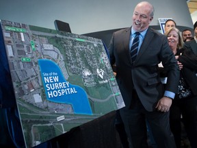 British Columbia Premier John Horgan unveils a satellite image map showing where a new hospital will be built in Surrey, B.C., on Monday December 9, 2019.