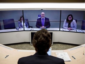 Premier John Horgan, top, meets Prime Minister Justin Trudeau via video conference from Victoria to Vancouver on Monday, after an in-person meeting was cancelled due to weather.