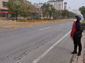 Edward Yuan, 27, of Vancouver stands on deserted street at around 8 a.m. on Jan. 29, 2020 in Wuhan, after a travel ban to try to contain the coronavirus flu outbreak.