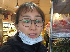Jin Kim, who works at Sandy Farm Market, a small Kerrisdale fruit and vegetable shop, has been wearing a mask while she works due to the coronavirus outbreak.