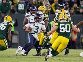 GREEN BAY, WISCONSIN - JANUARY 12: Russell Wilson #3 of the Seattle Seahawks runs with the ball during the second half against the Green Bay Packers in the NFC Divisional Playoff game at Lambeau Field on January 12, 2020 in Green Bay, Wisconsin.