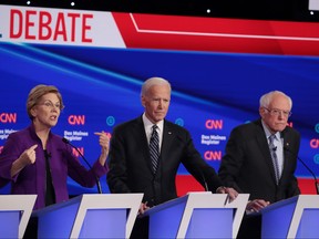 Sen. Elizabeth Warren (D-MA) speaks as former Vice President Joe Biden, centre, and Sen. Bernie Sanders (I-VT) listen during the Democratic presidential primary debate at Drake University on Jan. 14, 2020 in Des Moines, Iowa. (Scott Olson/Getty Images)