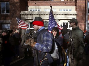 Gun rights advocates attend a rally organized by The Virginia Citizens Defense League on Capitol Square near the state capitol building in Richmond, Va., on Jan. 20, 2020.