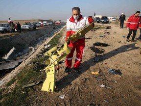 Rescue teams recover debris from a field after a Ukrainian plane carrying 176 passengers crashed near Imam Khomeini airport in the Iranian capital Tehran early in the morning on January 8, 2020, killing everyone on board. (AFP/Getty Images)