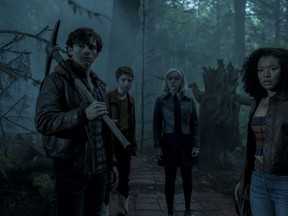 From left, Harvey Kinkle (Ross Lynch), Susie Putnam (Lachlan Watson), Sabrina Spellman (Kiernan Shipka) and Rosalind Walker (Jaz Sinclair) in the forest in hell in a scene from season three of the Chilling Adventures of Sabrina.