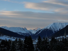 The sun rises behind snow-covered mountains as morning breaks on the opening day of the World Economic Forum (WEF) in Davos, Switzerland, on Tuesday, Jan. 21, 2020.