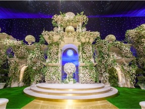 A grand wedding altar with floral art by Mark's Garden.