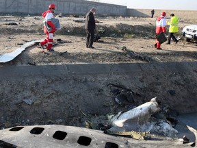 Rescue teams recover debris from a field after a Ukrainian plane carrying 176 passengers crashed near Imam Khomeini airport in the Iranian capital early on Jan. 8.