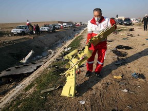 Rescue teams recover debris from a field after a Ukrainian plane carrying 176 passengers crashed near Imam Khomeini airport in the Iranian capital early on Jan. 8.